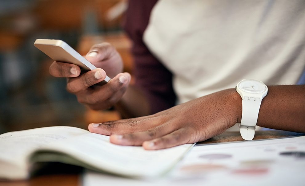 Women of color holding a smart phone